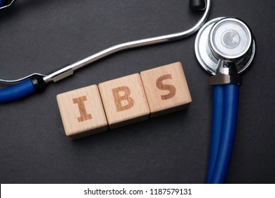 Wooden Block Form The Word IBS With Stethoscope. Medical Concept.