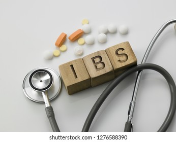 Wooden Block Form The Word IBS With Stethoscope. Medical Concept