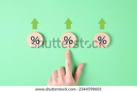 Wooden block with percentage and arrow sign icons, Interest rate increases, Profit from deposit money, Successful business investment, Money savings for future, Interest rate and mortgage rates