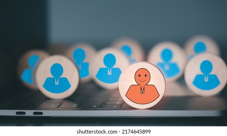 The wooden block is placed on the laptop, the concept of choosing and giving opportunities to the top performers, and promotion. - Shutterstock ID 2174645899