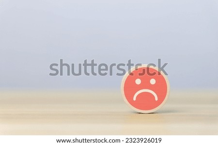 Wooden block showing the angry icon. Customer review experience Dissatisfied Choosing a 1-star rating review Negative idea of unhappy, poor service or poor quality