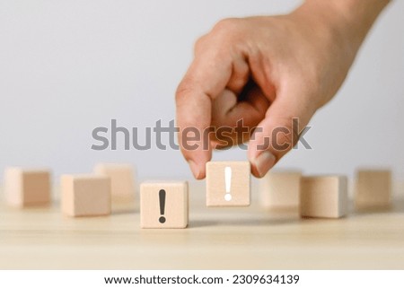 Wooden block showing white exclamation mark, warning, error, notification, maintenance and solution finding, white background.