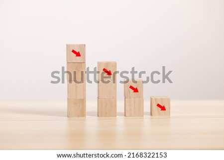 Wooden block stack to downturn graph. Concept for recession economy and declineing graph.
