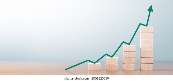 Wooden Block Statistics Graph With Arrow Showing Exponential Growth Trend