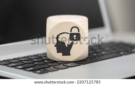 Wooden block with symbol of intellectual property concept on laptop keyboard