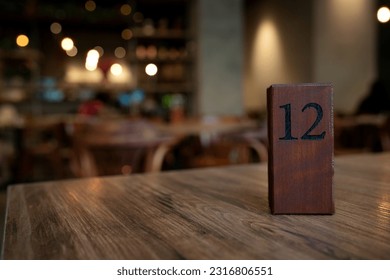 Wooden block table number in a cafe - Shutterstock ID 2316806551