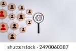 Wooden block with target icon linked with human icons for customer focus group, Customer relationship management concept, CRM, Customer relationship management and targeted marketing strategies.