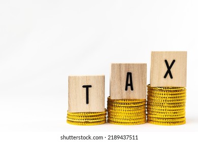 Wooden Block Tax And Toy Gold Coins. Image Of Tax Increase