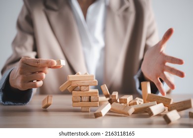 Wooden Block Tower Collapse With Woman Hand, Business Strategy Concept