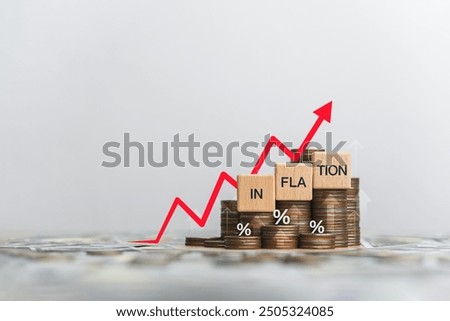 Wooden block and the word inflation on a coin placed. Inflation concept for the FED. Considering raising interest rates. Global economy, bankruptcy and controlling inflation. US dollar inflation.