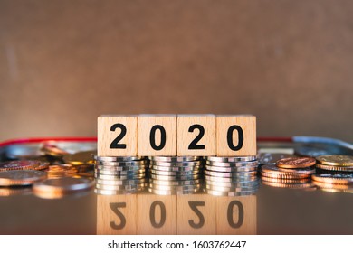 Wooden Block Year 2020 With Stack Coins Using As Business Banking And Financial Concept