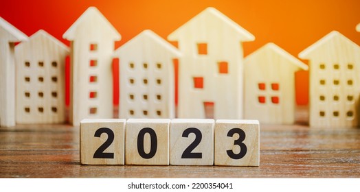 Wooden blocks 2022 and houses. Family budget planning for next year. Investments, plans, savings. Mortgage rates. Real estate concept. Refinance home. - Shutterstock ID 2200354041