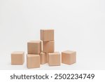 Wooden blocks in ascending order showing growth concept on a plain white background. Ideal for business, education, and development themes.