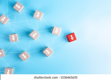 Wooden blocks with businessman icon on blue background, Organisation structure, social network, Leadership, team building, recruitment business, management and human resources concepts. copy space
