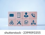 Wooden blocks with call center support icon on white background. Worldwide full-time available contact for service. Assistance customer services and delivery. Technician ready for service 24 hours.