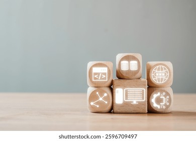 Wooden blocks with digital icons symbolizing various aspects of information technology on a simple background.