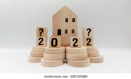 Wooden Blocks And Discs Stacked To Represent The 2022 Housing Market