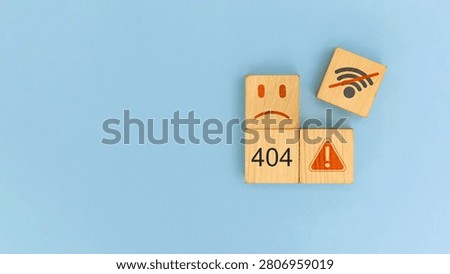 Wooden blocks displaying 404 error, warning symbol, unhappy face and no Wi-Fi icon, representing website downtime, internet connection failure, network outage, technical issues, troubleshooting and IT support.