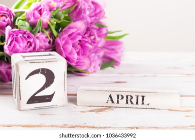 Wooden Blocks With Easter Monday Date, 2 April, Purple Tulips Nearby