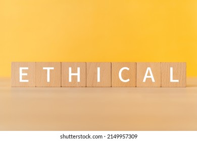 Wooden blocks with "ETHICAL" text of concept.