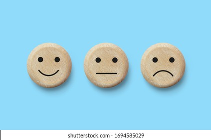 Wooden Blocks With Facial Expressions Negative, Neutral And Positive. Customer Service Experience And Satisfaction Survey Concept . Feedback Icons For Client