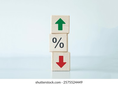 Wooden blocks with green arrow up and red down with percentage icon. Business planning for target achievement