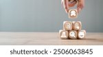 Wooden blocks with icons symbolizing ISO 9001 certification, quality management, standards, and continuous improvement in a business context.