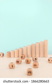 Wooden Blocks As Increasing Graph Bar. Dice Stack On White Table. Concept For Business Risk, Chance, Or Growth. Random Number Generator. Copy Space