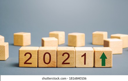 Wooden Blocks With The Inscription 2021 And An Up Arrow. The Forecast Concept For 2021. Business Forecasting. Growth And Development Of Business And Economy. Vision. Targets And Goals