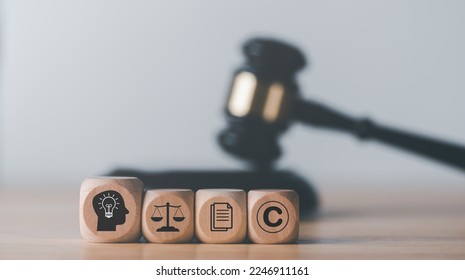 wooden blocks and Wooden judge gavel on the table, concept of copyright or intellectual property patent protection of copyright infringement proprietary declaration Legitimate innovations - Shutterstock ID 2246911161