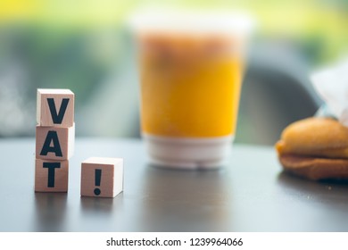 Wooden blocks with letters VAT. VAT is acronym from word Value Added Tax. Vat payment from customer in super market : Government Vat from goods