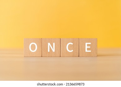 Wooden blocks with "ONCE" text of concept.
