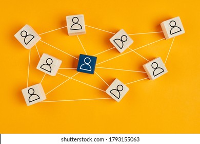 Wooden blocks with people icon on yellow background. Organization structure, social network, leadership, team building, job recruitment, management or human resources concepts.