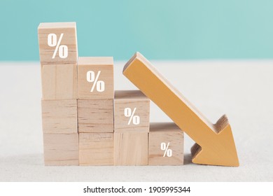 Wooden blocks with percentage sign and down arrow, financial recession crisis, interest rate decline, investment reduce, risk management concept