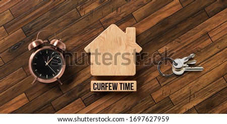 wooden blocks in shape of a house with text CURFEW TIME on wooden background