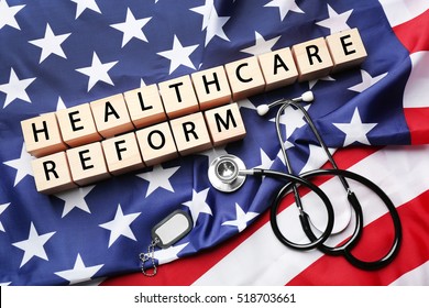 Wooden blocks with space for text, stethoscope and tag on American national flag - Shutterstock ID 518703661