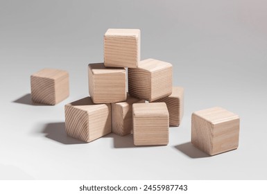 Wooden blocks stacked in educational play. Business and economy concepts learned through abstract building game. School of development and knowledge, construction of answers and solutions. - Powered by Shutterstock