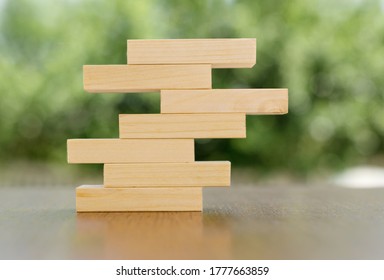 Wooden Blocks Stacked On Top Of Each Other Block On The Table. The Concept Of Business, Growth, Elements For Your Design.