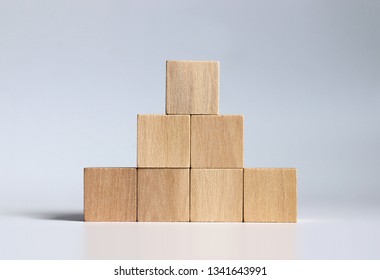 Wooden blocks stacked in the shape of a pyramid.