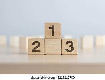 Wooden Blocks Stacking As A Podium On White Background. Success, Win, Winner, Victory Or Top Ranking Concept.