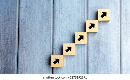 wooden blocks stacking as step stair with arrow up, Business growth success process concept, copy space - Shutterstock ID 2175192891