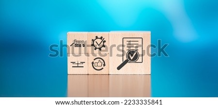 Wooden blocks with symbol of assessment concept on blue background