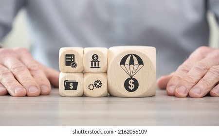 Wooden Blocks With Symbol Of Government Aid Concept