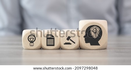 Wooden blocks with symbol of intellectual property concept