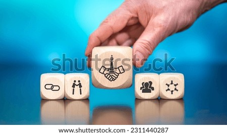 Wooden blocks with symbol of strategic alliance concept on blue background