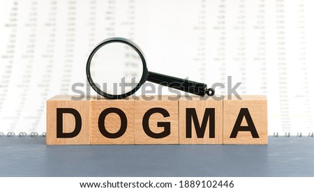 Wooden blocks with the text: dogma. Dogma word made with building blocks, business concept
