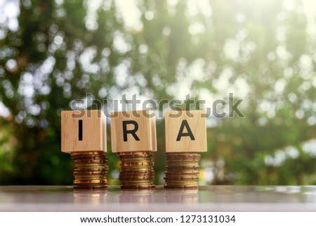 Wooden blocks with text IRA Business and finance concept.