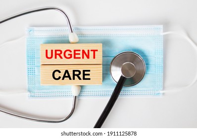 Wooden Blocks With Text Urgent Care Lying On The Mask And A Stethoscope. Medical Concept