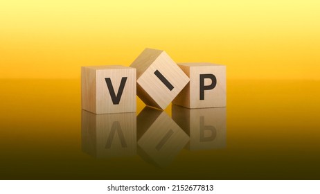 wooden blocks with text VIP on yellow baclground. Very Important Person concept
