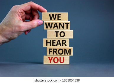 Wooden Blocks With Text 'we Want To Hear From You'. Male Hand. Beautiful Grey Background, Copy Space. Business Concept.